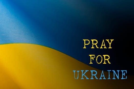 Pray for Ukraine concept background. National Ukrainian flag. Concept symbol of help support and no war in the country of Ukraine.