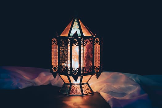 Ramadan Kareem background. Ornamental Arabic lantern glowing at night