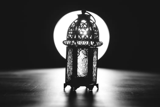 Ramadan Kareem background. Ornamental Arabic lantern glowing at night