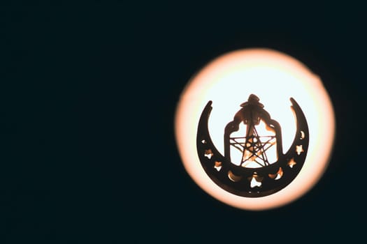 Ramadan Kareem background. Ornamental Arabic lantern glowing at night