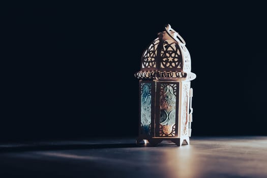 Ramadan Kareem background. Ornamental Arabic lantern glowing at night