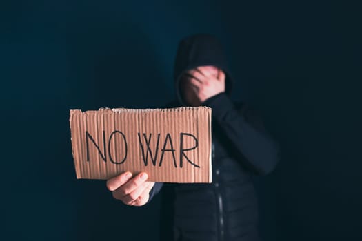 Man holding placard No war text. Freedom to Ukraine concept.