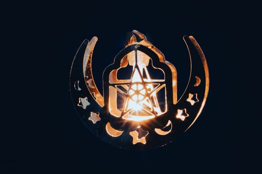 Ramadan Kareem background. Ornamental Arabic lantern glowing at night
