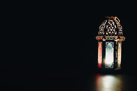 Ramadan Kareem background. Ornamental Arabic lantern glowing at night