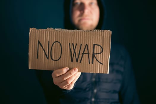Man holding placard No war text. Freedom to Ukraine concept.