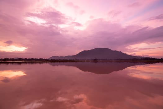Beautiful morning red sky reflection of the hill in water