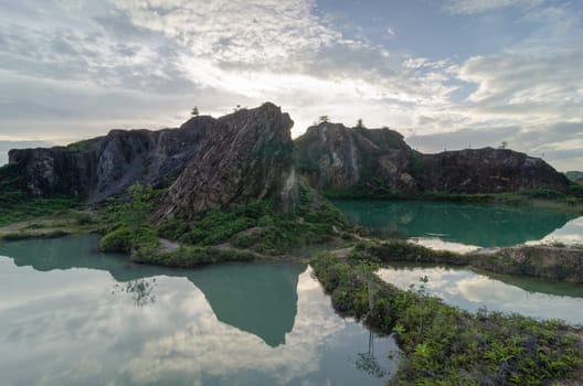 Beautiful scenery reflection of abandoned quarry hill in day