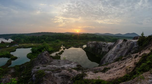 Sunrise at the cliff and lake near the abandoned quarry