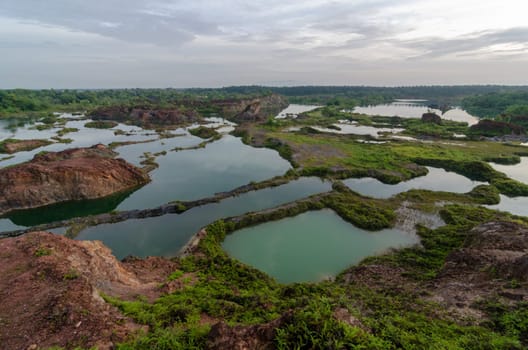Quarry lake with different green and blue color view from top