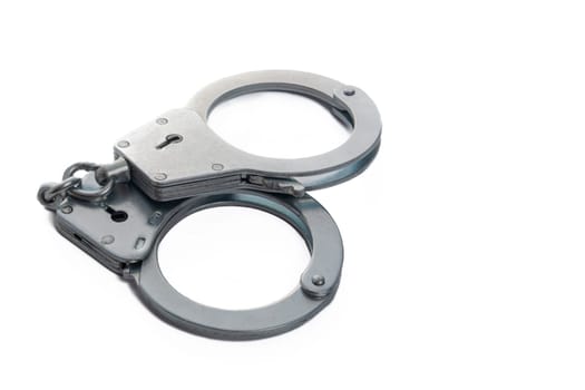 Metal handcuffs on a white isolated background, copy space. High quality photo