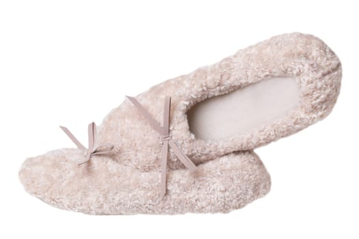 Slippers isolated. Close-up of a pair of female beige warm and soft cosy terry slippers isolated on white background.  Womans shoes.