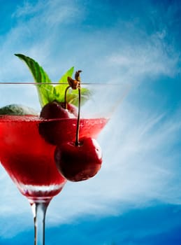 Cherry cocktail on the beach in retro style