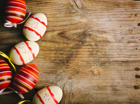Easter eggs on rustic wooden table in retro style.