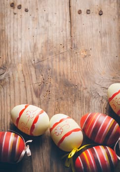 Easter eggs on rustic wooden table in retro style.