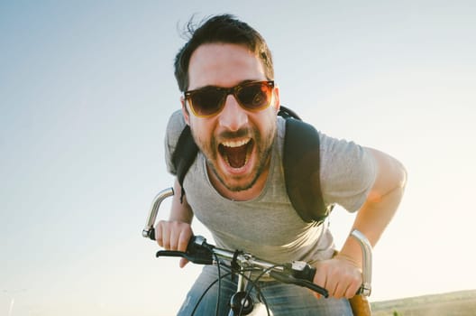 Man with bicycle having fun. retro style image.