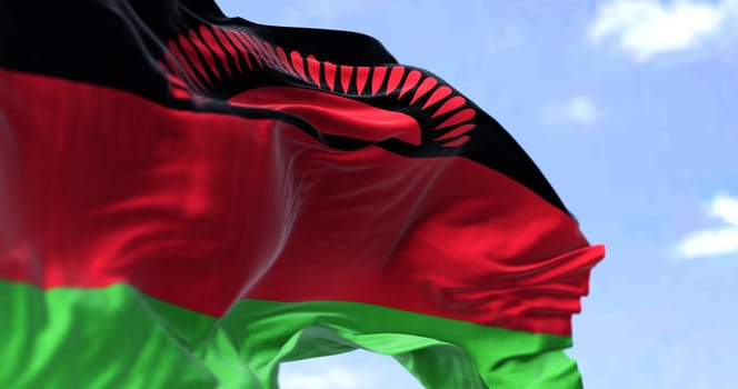 Detail of the national flag of Malawi waving in the wind on a clear day. Malawi is a landlocked country in Southeastern Africa. Selective focus.