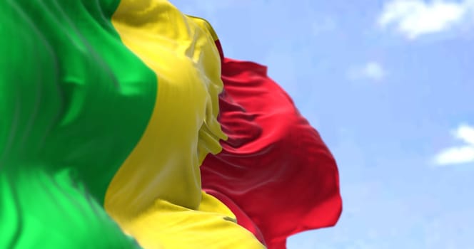 Detail of the national flag of Mali waving in the wind on a clear day. Mali is a landlocked country in West Africa. Selective focus.