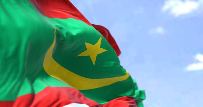 Detail of the national flag of Mauritania waving in the wind on a clear day. Mauritania is a sovereign state in Northwest Africa. Selective focus.