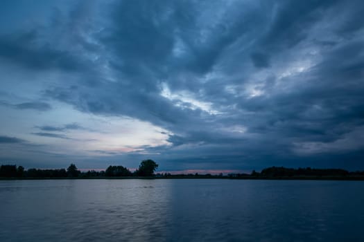 Cloudy evening sky over a calm lake, Stankow, Lubelskie, Poland