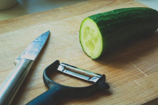 A simple knife or a green cucumber peeler