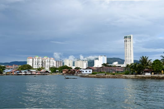 Georgetown, Penang, Malaysia - Oct 13 2017: KOMTAR building and old wooden stilt house and apartment, condo view from sea