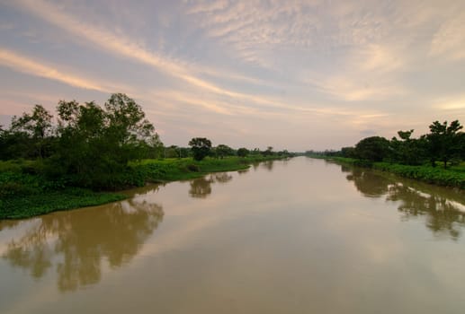 Seberang Perai, Kuala Lumpur, Malaysia - Circa Jun 2018: Reflection of the green scenery trees during sunset
