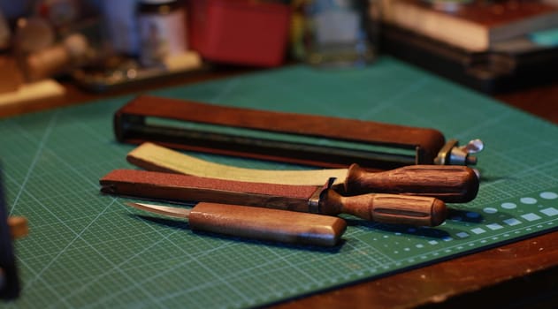 wood cutter and a manual sharpening tool on a table