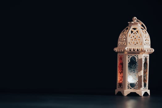 Ramadan Kareem background. Ornamental Arabic lantern glowing at night