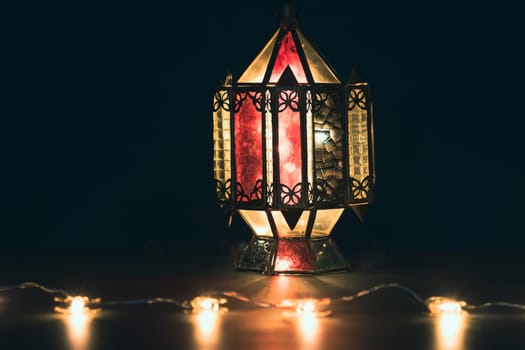 Ramadan Kareem background. Ornamental Arabic lantern glowing at night