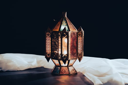 Ramadan Kareem background. Ornamental Arabic lantern glowing at night