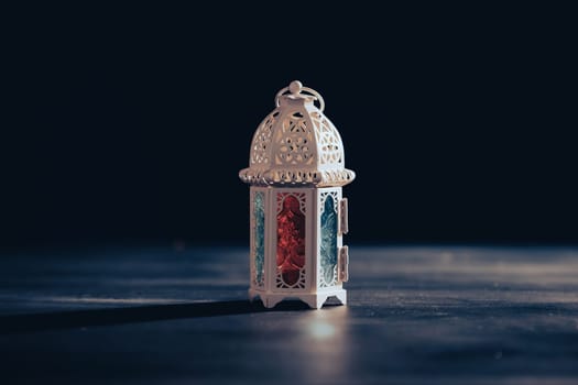 Ramadan Kareem background. Ornamental Arabic lantern glowing at night