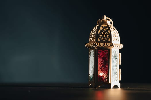Ramadan Kareem background. Ornamental Arabic lantern glowing at night