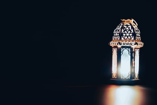 Ramadan Kareem background. Ornamental Arabic lantern glowing at night