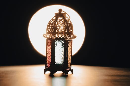 Ramadan Kareem background. Ornamental Arabic lantern glowing at night
