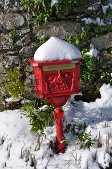 Vintage red mailbox under the snow
