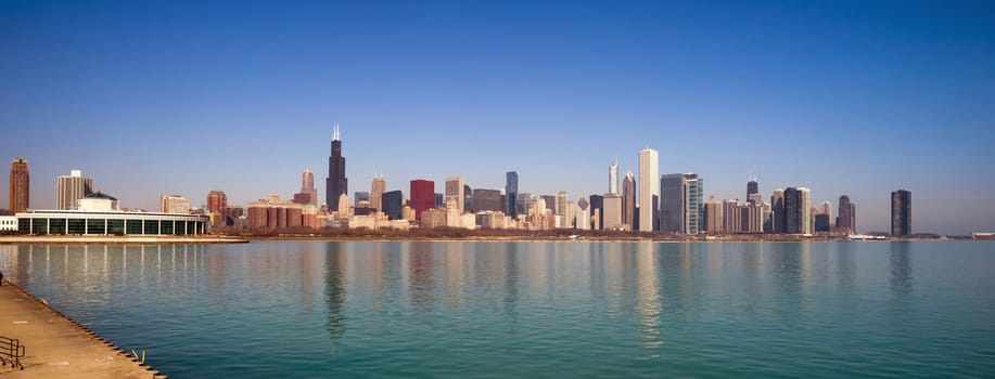 A beautiful pink sunrise lights the long downtown Chicago skyline