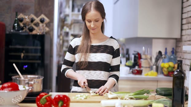 Young woman cooking in kitchen at home, healthy eating.
