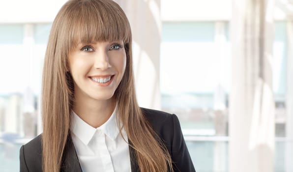Portrait of happy young beautiful white businesswoman smiling. Copy space for text.