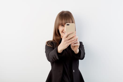 Happy white young business women taking selfie with phone.