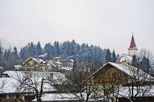 Village with church in winter