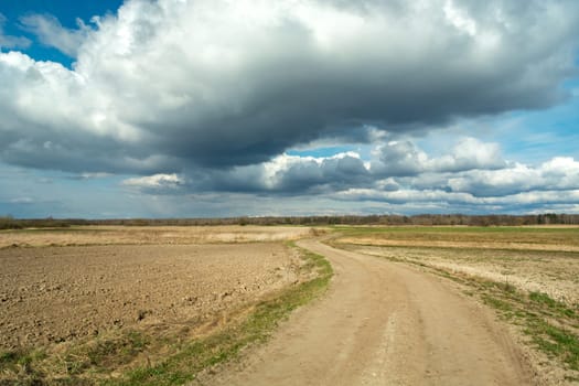 A sandy road through the fields and clouds on the sky, Czulczyce, Poland