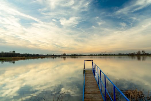 A pier at the water reservoir and the sky after sunset, Staw, Poland