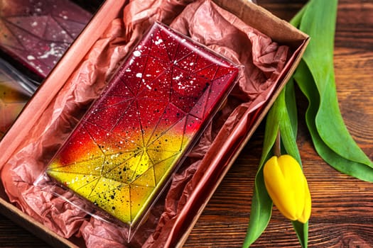 set of real Belgian handmade chocolate with berries and nuts using natural dyes on a dark background