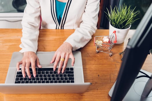 Young business woman working typing laptop computer on desk office