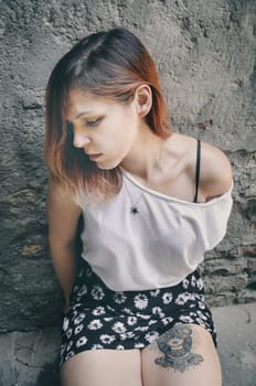 Young woman with tattoo on her leg