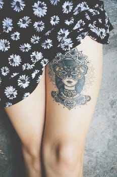 Attractive female leg with tattoo