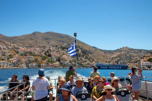 RHODES, Greece - JUN 03, 2021. View of tourists leaving the island of SYMI on a Greek speedboat heading for the Greek island of Rhodes.