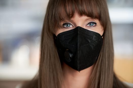Coronavirus - Closeup portrait of beautiful young women in black face mask.