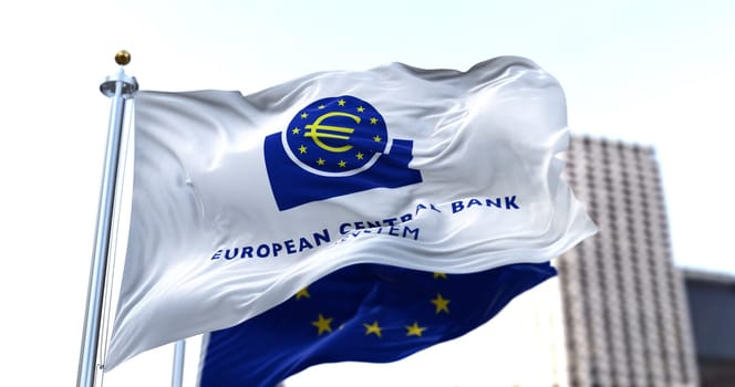 Frankfurt, GER, March 2022: The flag of the European Central Bank waving in the wind with the European Union flag blurred in the background. European currency.