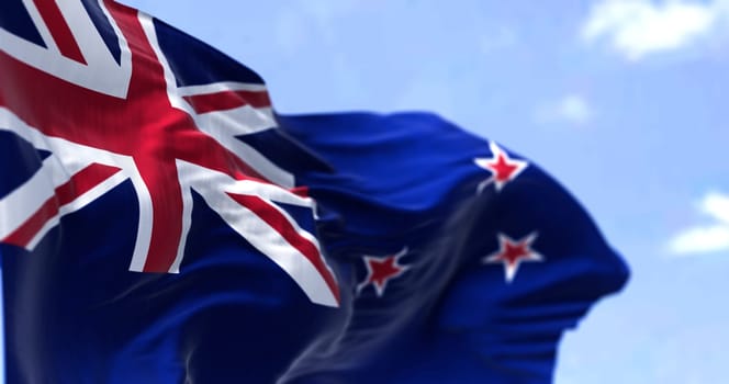Detail of the national flag of New Zealand waving in the wind on a clear day. New Zealand is an island country in the southwestern Pacific Ocean. Selective focus.
